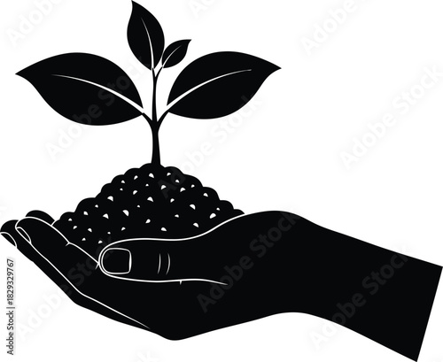 Hand holding plant seedling in soil black and white