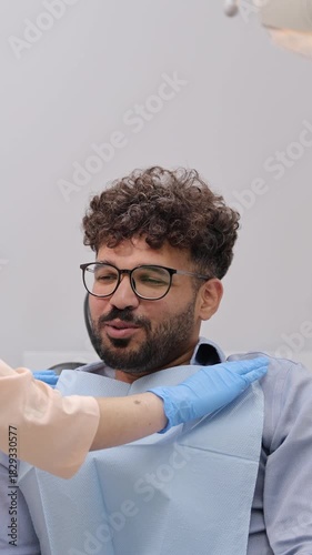 Portrait of a young happy smiling man at a dentist's appointment
