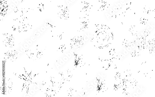 Black ink splatters and smudges scattered across a white background abstract blotch
