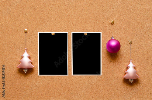 Empty photos and Christmas tree toys are pinned on a cork board. Copy space
