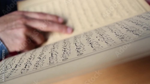 Muslim Reading Islamic Holy Book finger pointing text quran text al-quran background