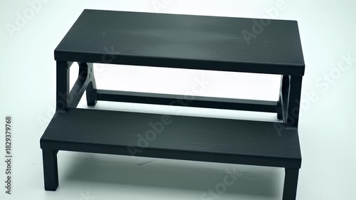 Two Tiered Black Step Stool with Textured Surfaces on a White Background