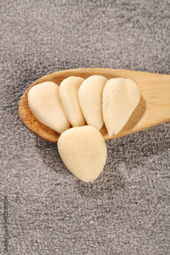 Peeled Sweet Almond Slices in Wooden Spoon - Dried Nuts and Healthy Food Ingredient