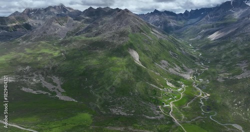 Beautiful green grassland and snow capped mountain in Litang county, China