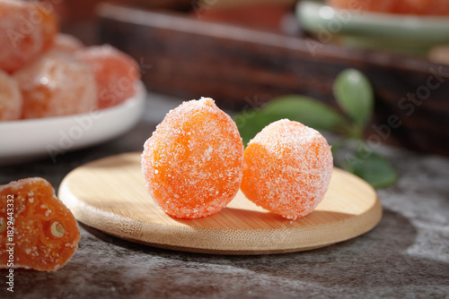 Candied Kumquat Fruit with Sugar Coating on Wooden Plate - Traditional Sweet Preserve Confection
