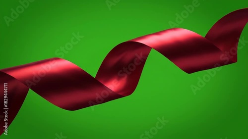 Elegant Red Satin Ribbon Waving Gracefully on a Green Background.