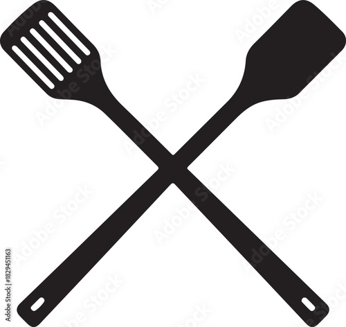 Two crossed black kitchen spatulas on white background