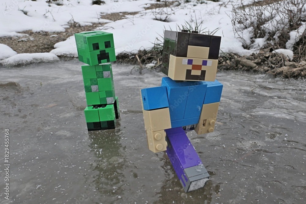 Naklejka premium LEGO Minecraft action figure of smiling Steve gliding on ice puddle while escaping green explosive Creeper mob chasing him, snowy field and some grass in background.