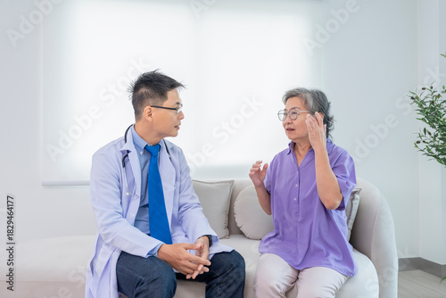specialist doctor in uniform taking medical history a senior woman who suffer from headache in examination room