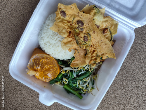 Nasi pecel and sego pecel are typical Javanese Indonesian rice dishes served with pecel sauce, vegetables and others.	