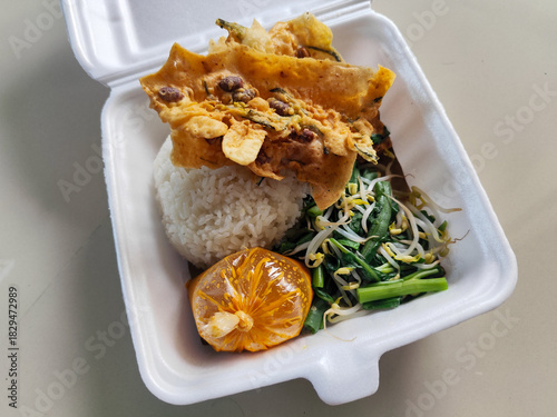 Nasi pecel and sego pecel are typical Javanese Indonesian rice dishes served with pecel sauce, vegetables and others.	