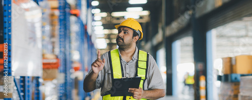 Warehouse worker working in warehouse storage. Foreman or worker work at factory site check up products in site. Inventory worker working in  factory Storehouse