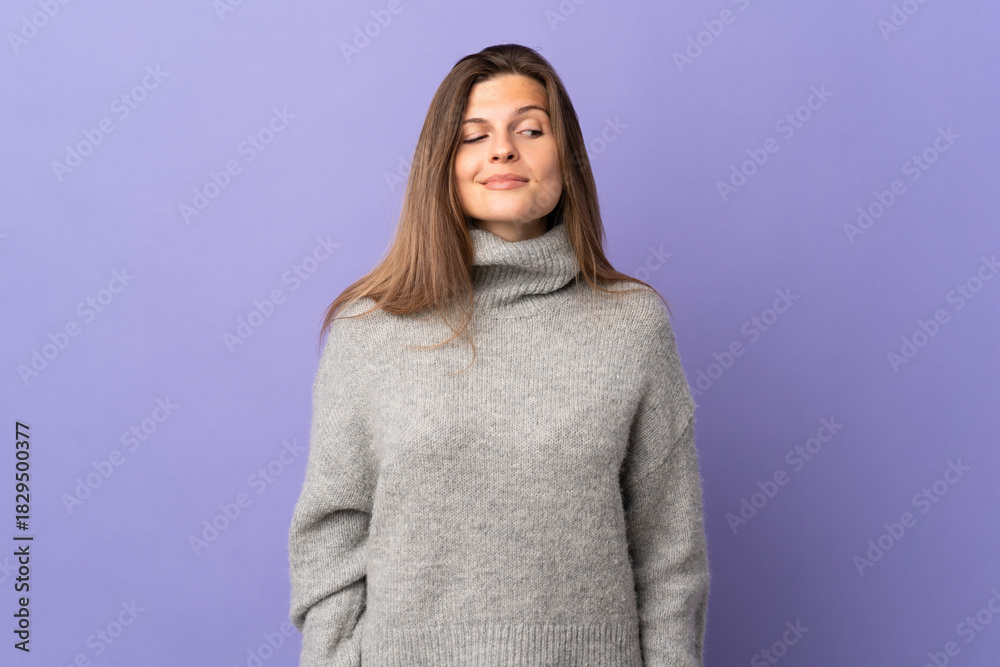 Fototapeta premium Young Slovak woman isolated on purple background having doubts while looking side