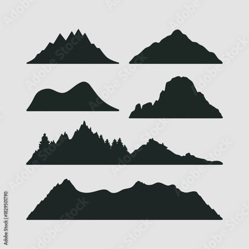 Set of seven different mountain silhouettes with various peaks and shapes, isolated on