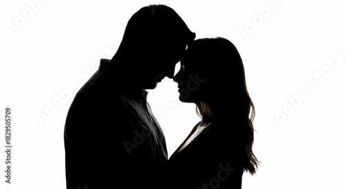 Silhouetted couple in intimate embrace, sharing a tender moment of connection.