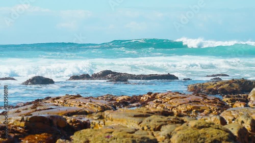 Slow motion, layers of blue giant waves rolling on the sea under the sunlight