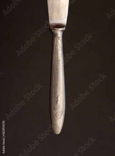 Metal knife handle on a black background.