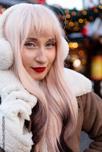 Young blonde woman at the Christmas market. Holiday Portrait with Christmas Market Background.