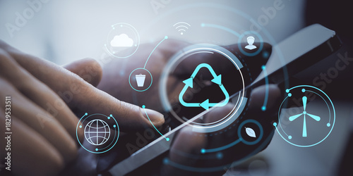 Smartphone in hand with digital recycling and eco icons on futuristic interface background representing sustainable technology use.