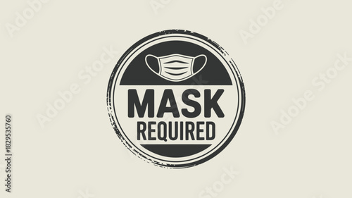 A circular sign with a mask icon and the words mask required in bold black letters on a light background