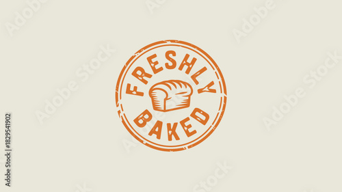 A vintage style orange stamp with the words freshly baked and a loaf of bread in the center