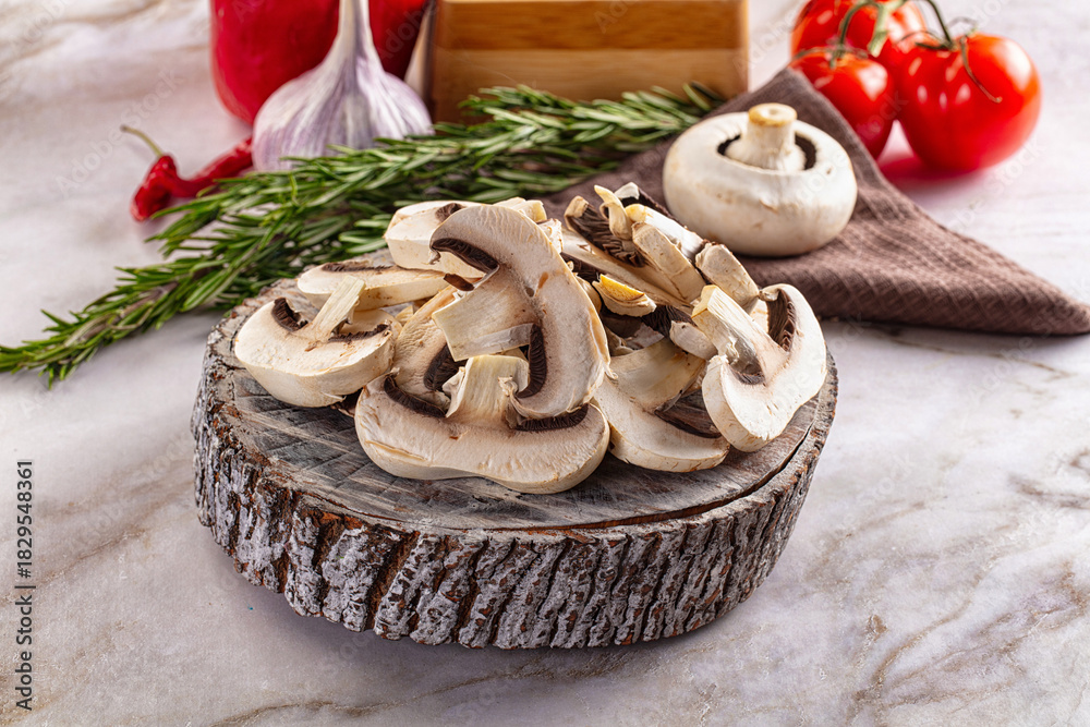 Fototapeta premium Raw champignon slices on the board