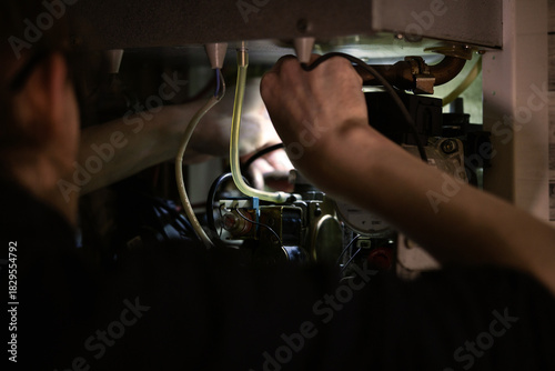 The repairman fixes the heating system. Boiler repair.