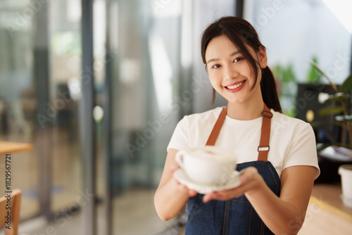 Asian woman barista serving hot coffee beverage