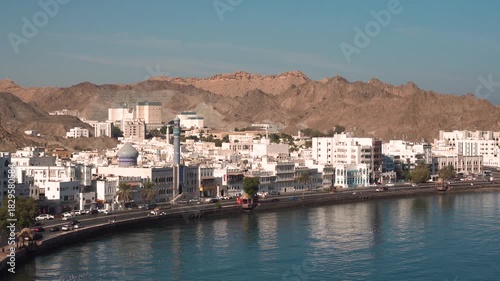 View of Mutrah Corniche with seaside promenade and rocky hills in Muscat