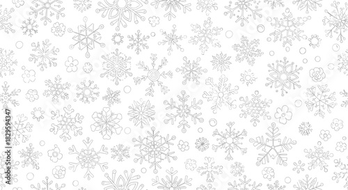 Intricate black and white seamless pattern featuring various snowflake designs, small flowers, and scattered dots for winter and holiday themes.
