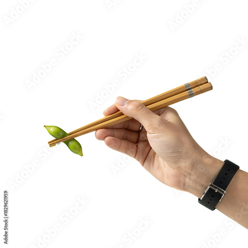 Hand holding chopsticks with a piece of green vegetable