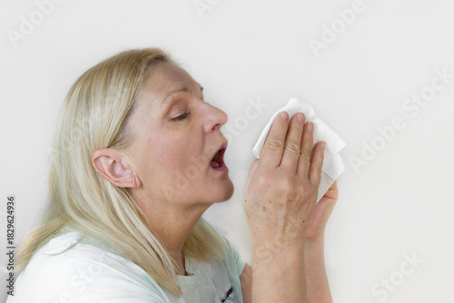 Senior woman is about to sneeze. Cold or flu concept