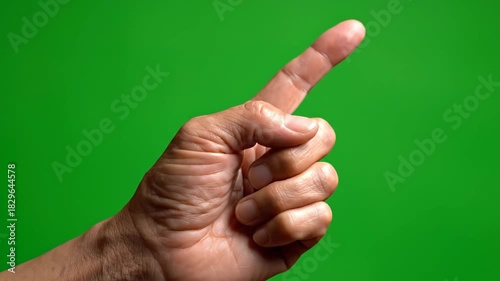 A detailed close-up of a hand with the index finger extended in a pointing gesture, isolated on a green screen for chroma key effects. 4K Footage