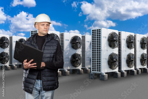 HVAC engineer inspects outd...