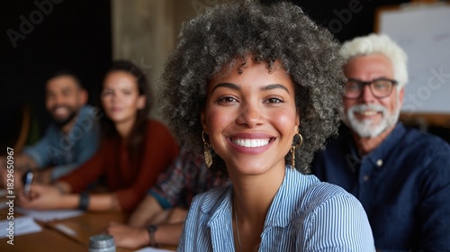 Diverse team of professionals in a conference room, smiling and engaged during a meeting.
