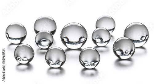 Collection of clear, reflective glass or crystal spheres isolated on white background