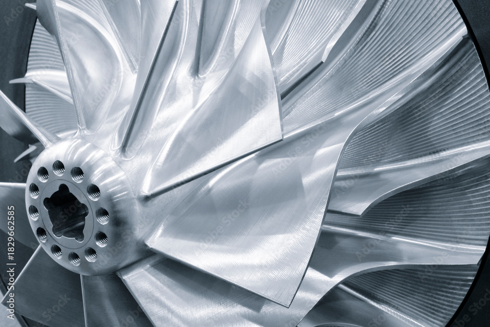 Naklejka premium A silver fan turbine blade with a hole in the center. The blades are curved and detailed. Industrial concept background.