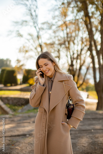 Smiling woman talking on he...