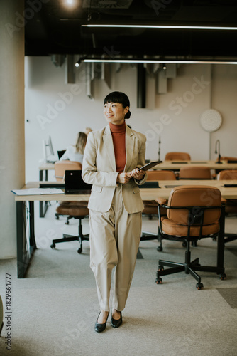 Professional woman standing...