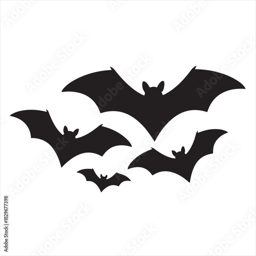 Silhouette of a group of bats flying in the night sky