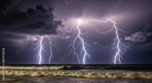 Fototapeta Naklejka Na Ścianę i Meble -  Powerful lightning strikes over ocean during a storm at night