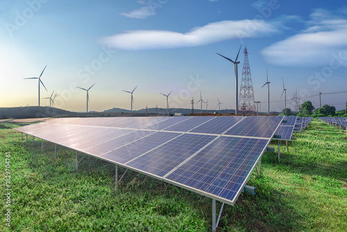 Renewable Energy, Solar panels and wind turbines on green grass in blue sky