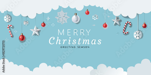 Festive christmas decorations hanging from a blue winter sky background