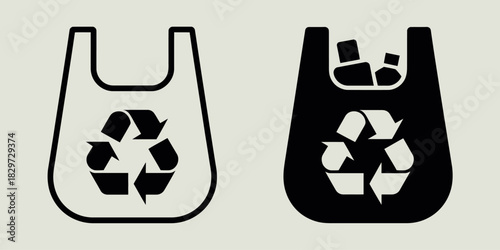 Two shopping bags one white and one black with recycling symbol