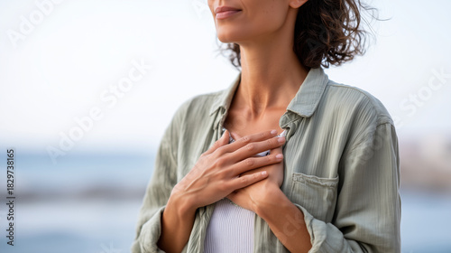 a person practicing slow breathing with hands on chest outdoors, mental well-being, 
