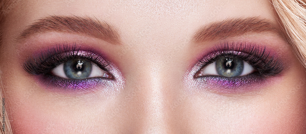Obraz premium Beautiful female eyes with long eyelashes. Eyelash extensions. Makeup, cosmetics, beauty. Close up, macro
