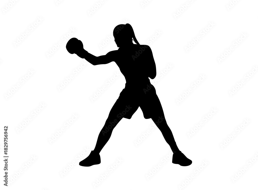 Obraz premium Silhouette of a female boxer throwing a punch in a fighting stance