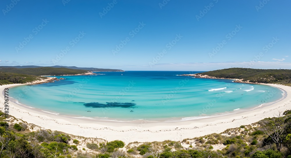 Obraz premium Panoramic view of a pristine beach with turquoise water, white sand and blue sky