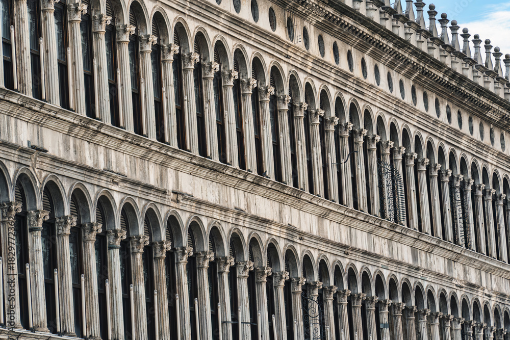 Fototapeta premium Historic classic building facade with arched windows and classical columns in Venice, Italy