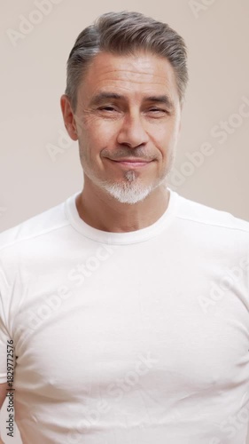 Portrait of happy casual older man smiling, Mid adult, mature age guy with gray hair, Isolated on white background, copy space.
